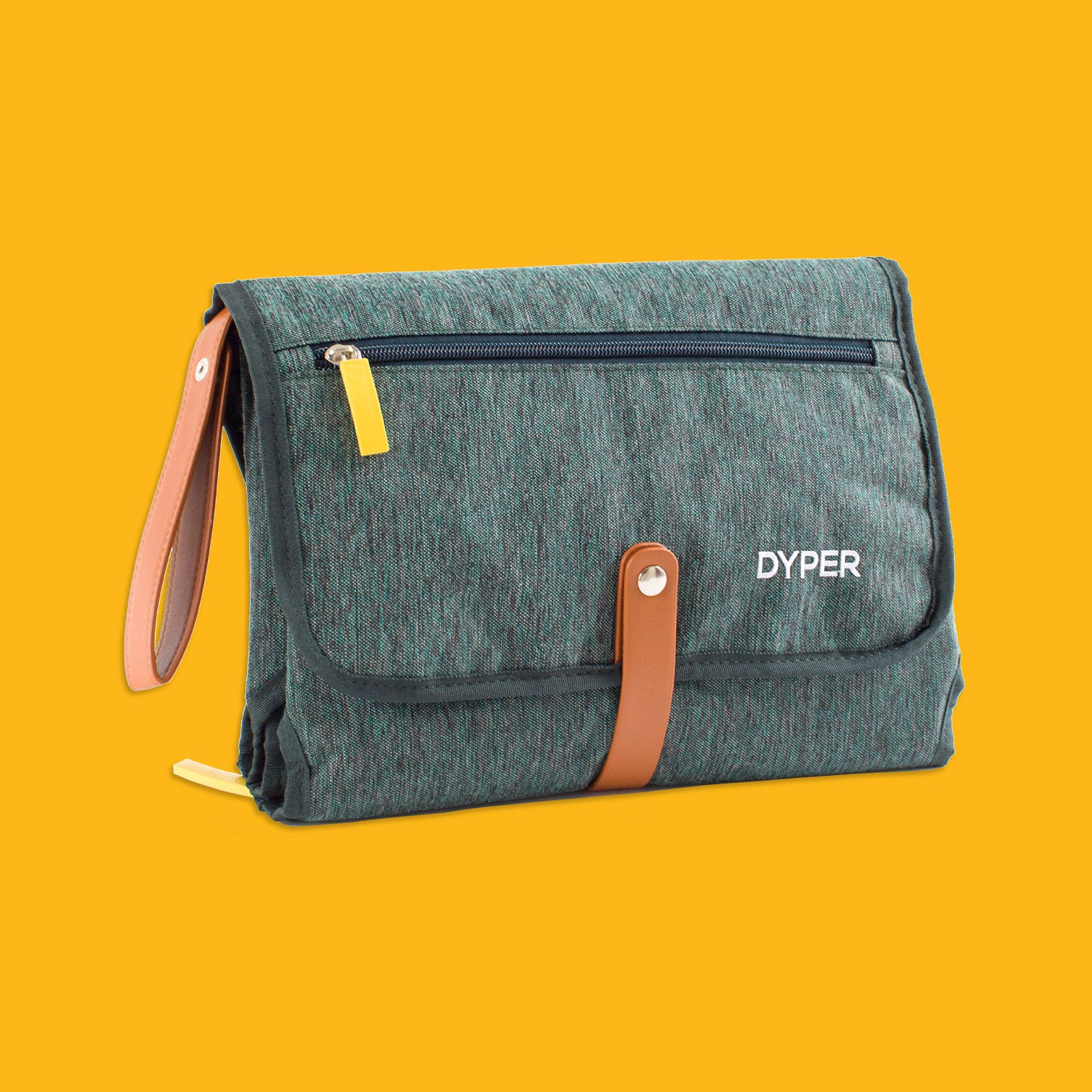 Green toiletry bag with brown straps on a yellow background