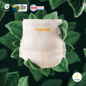 White diaper with green trim on a leafy green background, featuring Dyper branding and certification logos.
