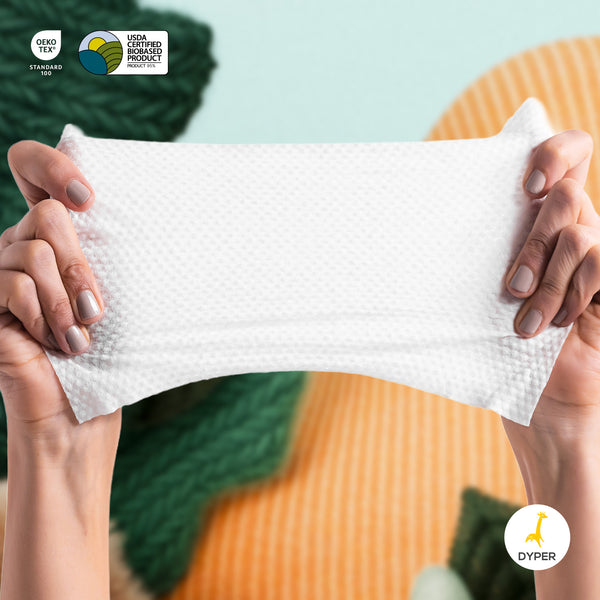 Person holding a white textured product with visible branding on a blurred background