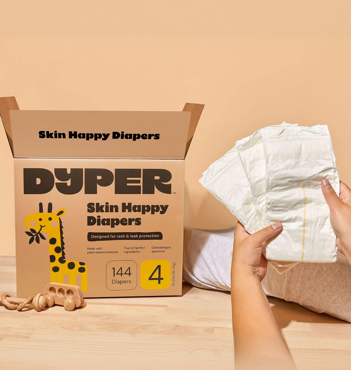A box of Dyper Skin Happy Diapers