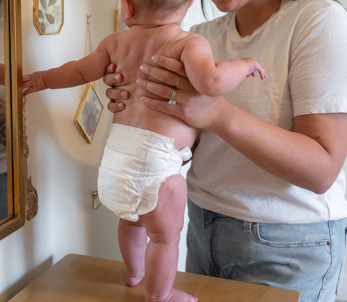 Parent holding a baby wearing a Dyper diaper
